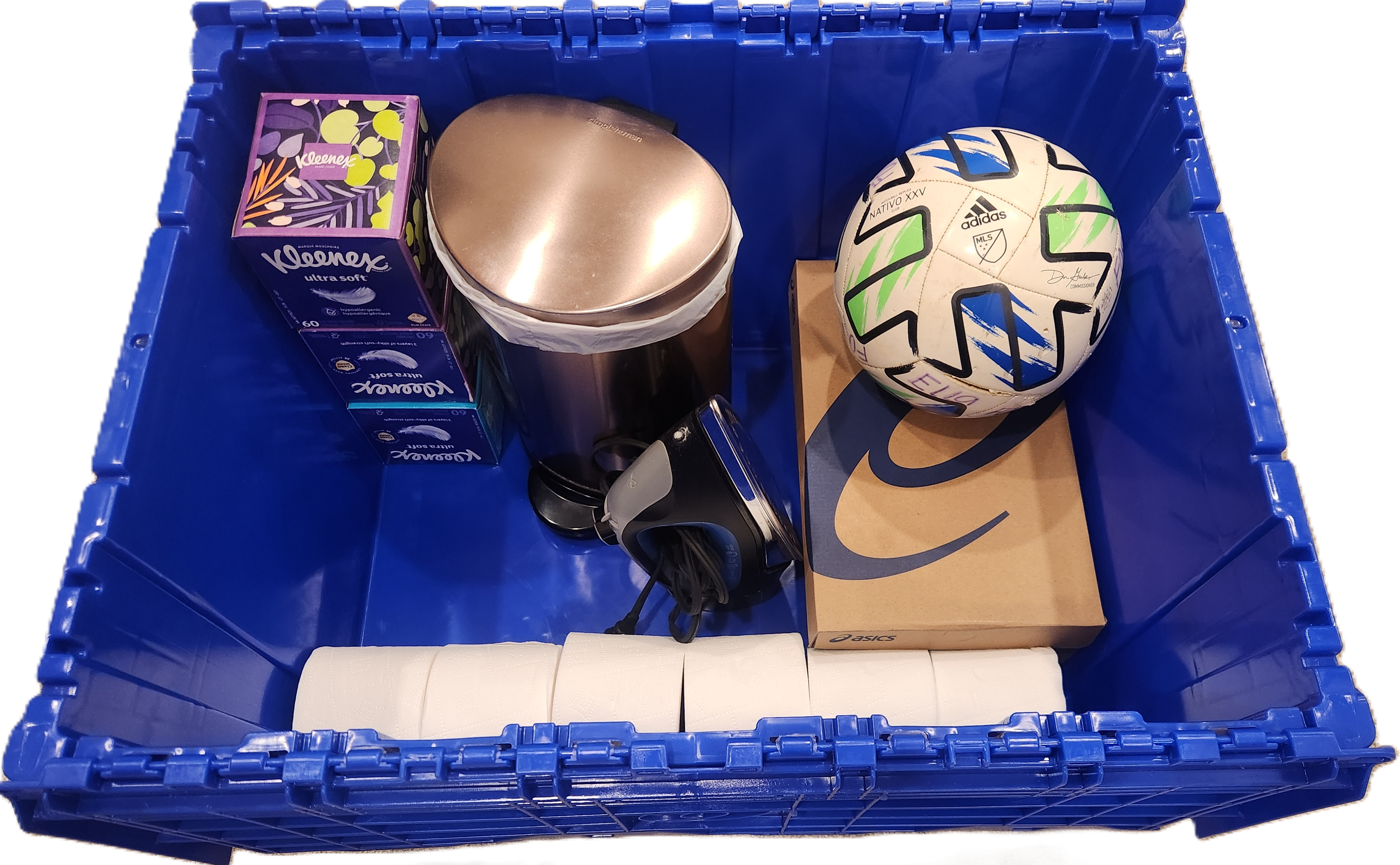 Real Toterly tote half packed with bedding, shoes, and common dorm items.